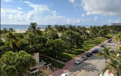 an aerial view of a street with palm trees and the beach at Hotel Breakwater South Beach in Miami Beach