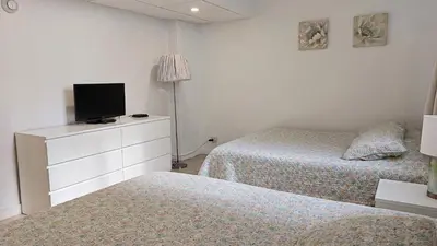 a bedroom with two beds and a dresser with a tv at THE TIDES 1 bedroom apt 8th floor WE ARE ON THE BEACH in Hollywood