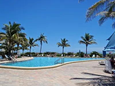 a swimming pool with palm trees in a resort at THE TIDES 1 bedroom apt 8th floor WE ARE ON THE BEACH in Hollywood