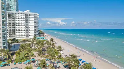 an aerial view of a beach with palm trees and buildings at THE TIDES 1 bedroom apt 8th floor WE ARE ON THE BEACH in Hollywood