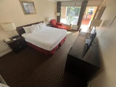 a hotel room with a bed and a flat screen tv at Grand Palms Spa & Golf Resort in Pembroke Pines