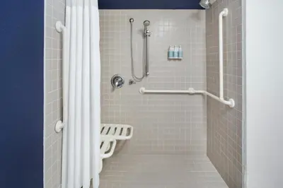 a shower with a white shower curtain in a bathroom at Residence Inn by Marriott Miami Airport in Miami