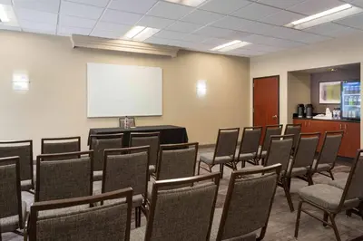a conference room with chairs and a white screen at Courtyard Miami Airport West Doral in Miami