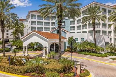 a hotel with palm trees in front of a building at Marriott's Villas At Doral in Miami