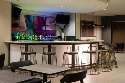 a bar in a restaurant with chairs and tables at SpringHill Suites Miami Downtown/Medical Center in Miami