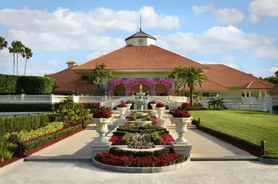a garden with flowers in front of a building at Trump National Doral Golf Resort in Miami