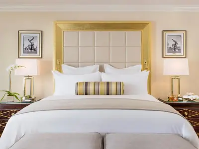 a bedroom with a large bed with two lamps at Trump National Doral Golf Resort in Miami