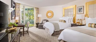 a hotel room with two beds and a desk at Trump National Doral Golf Resort in Miami