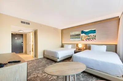 a hotel room with two beds and a table at Eden Roc Miami Beach in Miami Beach