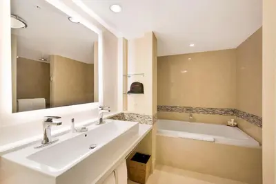 a bathroom with a sink and a bath tub at Eden Roc Miami Beach in Miami Beach