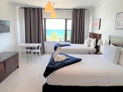 two beds in a hotel room with two swans on them at Ocean Front Units at Miami Beach in Miami Beach