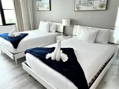 two beds in a hotel room with two white beds at Ocean Front Units at Miami Beach in Miami Beach
