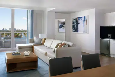 a living room with a couch and a table at The Ritz-Carlton, Fort Lauderdale in Fort Lauderdale