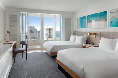 a hotel room with two beds and a large window at The Ritz-Carlton, Fort Lauderdale in Fort Lauderdale