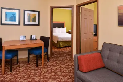 a hotel room with a desk and a bed at Candlewood Suites Miami Lakes by IHG in Miami Lakes
