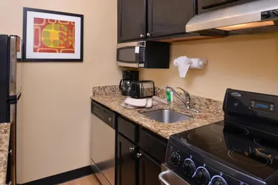 a kitchen with a sink and a counter top at Candlewood Suites Miami Lakes by IHG in Miami Lakes