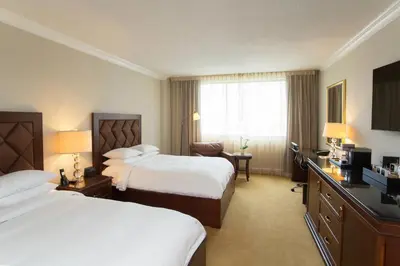 a hotel room with two beds and a television at JW Marriott Miami in Miami