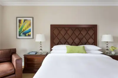 a bedroom with a large white bed and a chair at JW Marriott Miami in Miami