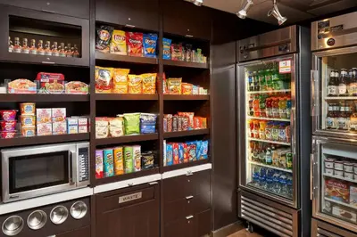 a kitchen with a refrigerator and a microwave at Sonesta Select Miami Lakes in Miami Lakes