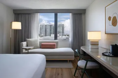 a hotel room with a bed and a desk and a window at Renaissance Fort Lauderdale Cruise Port Hotel in Fort Lauderdale