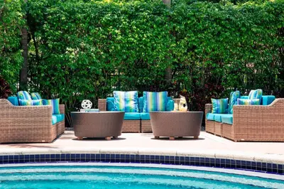a group of chairs sitting next to a swimming pool at Renaissance Fort Lauderdale Cruise Port Hotel in Fort Lauderdale