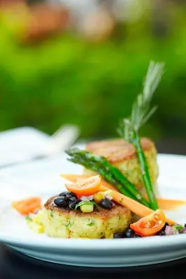 a plate of food with meat and vegetables on it at Renaissance Fort Lauderdale Cruise Port Hotel in Fort Lauderdale