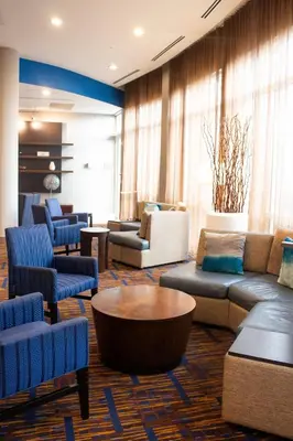 a lobby with couches and chairs and a coffee table at Courtyard Miami Dadeland in Miami