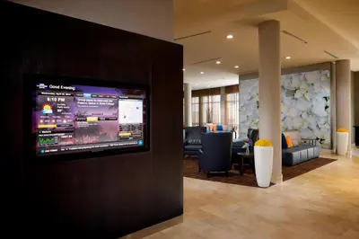 a lobby with a flat screen tv on a wall at Courtyard Miami Dadeland in Miami
