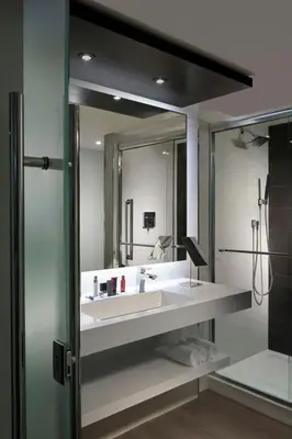 a bathroom with a sink and a large mirror at Miami Marriott Dadeland in Miami
