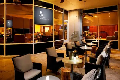 a lobby with chairs and tables and a restaurant at Miami Marriott Dadeland in Miami