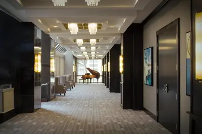 a hallway of a hotel with a piano in the distance at Miami Marriott Dadeland in Miami