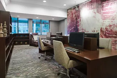 an office with a desk with a computer and chairs at Courtyard Miami Downtown Brickell Area in Miami