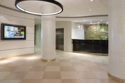 a lobby with a painting on the wall and columns at Courtyard Miami Coral Gables in Miami