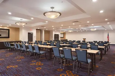 a large room with rows of tables and chairs at Courtyard Miami Coral Gables in Miami