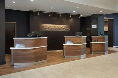 a lobby with wooden counter tops in a building at Courtyard by Marriott Fort Lauderdale Weston in Weston