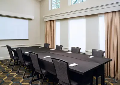 a conference room with a large black table and chairs at Residence Inn Fort Lauderdale SW/Miramar in Miramar