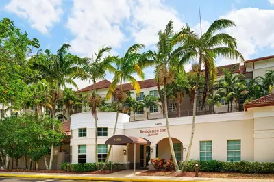 a hotel with palm trees in front of it at Residence Inn Fort Lauderdale SW/Miramar in Miramar