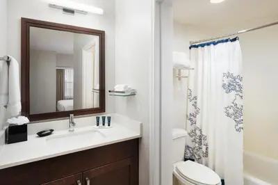 a bathroom with a sink and a toilet and a mirror at Residence Inn by Marriott Fort Lauderdale City of Plantation in Plantation