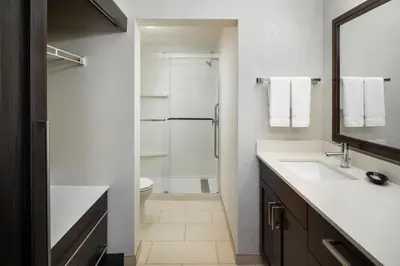 a bathroom with a shower and a sink and a toilet at Residence Inn by Marriott Fort Lauderdale City of Plantation in Plantation