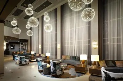 a lobby with couches and tables and chandeliers at Renaissance Fort Lauderdale West Hotel in Plantation