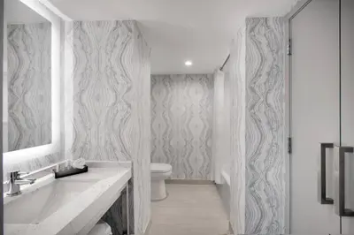 a white bathroom with a sink and a toilet at Courtyard by Marriott Miami Aventura Mall in Aventura