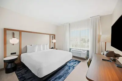a hotel room with a large bed and a desk at Fairfield Inn & Suites Fort Lauderdale Airport & Cruise Port in Dania Beach