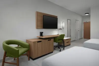 a hotel room with a desk and a tv at Fairfield Inn & Suites Fort Lauderdale Airport & Cruise Port in Dania Beach