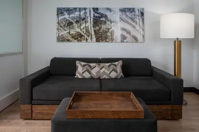 a living room with a couch with a coffee table at SpringHill Suites Fort Lauderdale Airport in Dania Beach