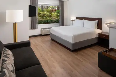 a hotel room with a bed and a couch at SpringHill Suites Fort Lauderdale Airport in Dania Beach