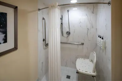 a bathroom with a shower with a toilet at SpringHill Suites Fort Lauderdale Airport in Dania Beach