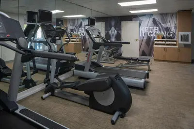 a gym with several treadmills and exercise bikes at SpringHill Suites Fort Lauderdale Airport in Dania Beach