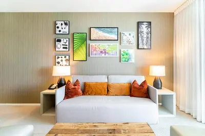 a living room with a white couch and pictures on the wall at Luxurious Hyde Resort Apartments in Hollywood