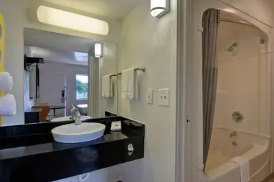 a bathroom with a sink and a shower at Motel 6 Dania Beach in Dania Beach