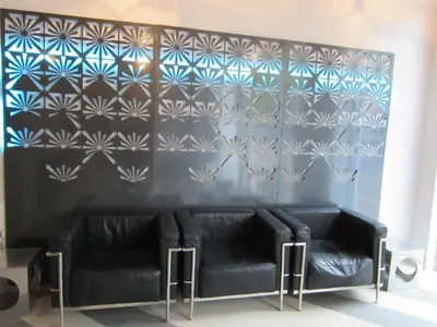 a room with two black leather couches against a blue wall at Miami Sun Hotel - Downtown/Port of Miami in Miami